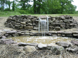 Stone Wall surrounding Water Fountain